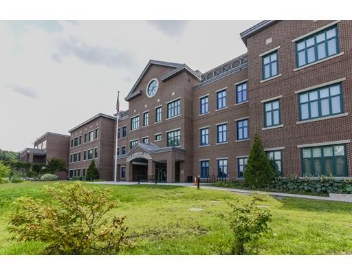 32 Birch Street Dedham, MA 02026 - Photo 20 of 25 a brick building with a yard in front of it