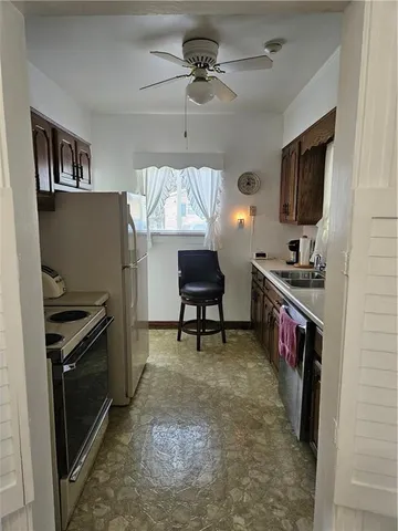 a bathroom with a toilet a sink and a window