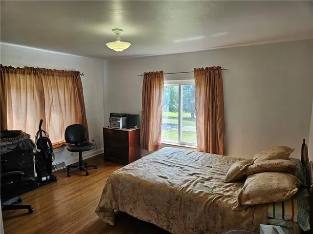 a view of a workspace with furniture and wooden floor