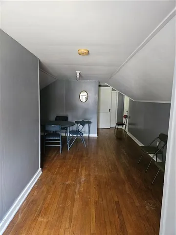 a bedroom with furniture and wooden floor