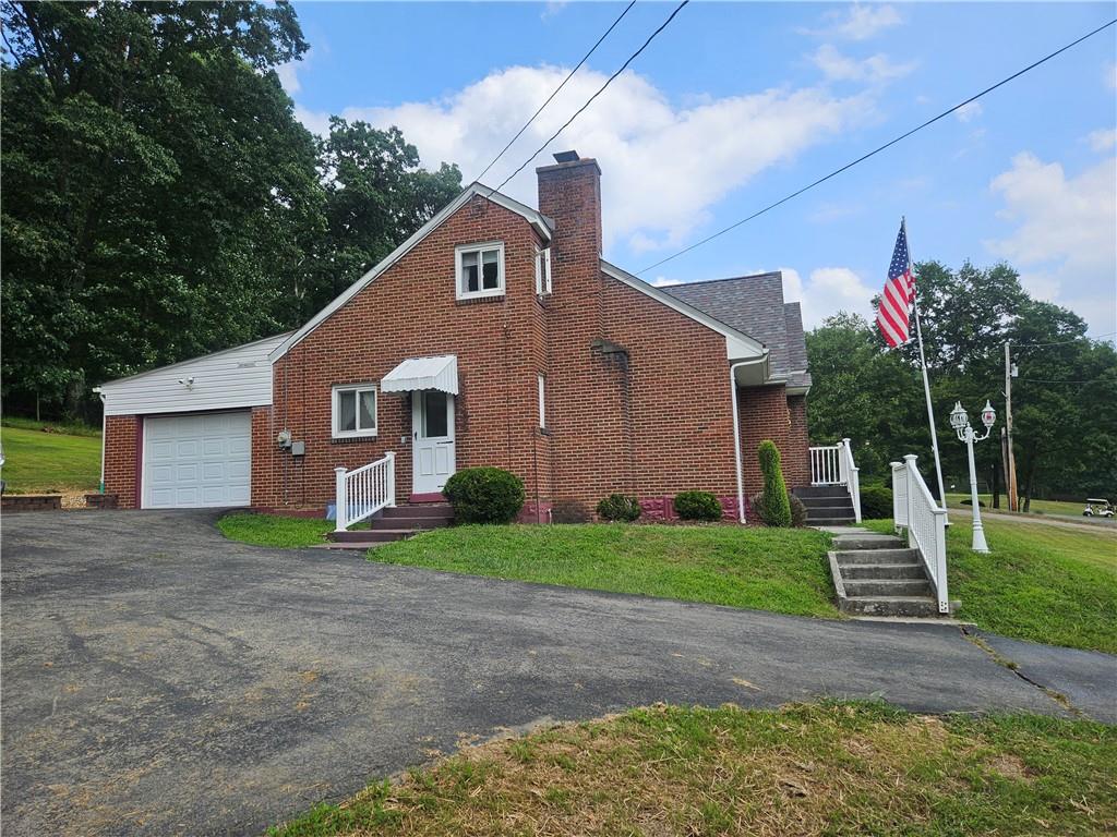 485 Harvey Road Foxburg, PA 16036 - Photo 6 of 25 a front view of a house with a yard and garage