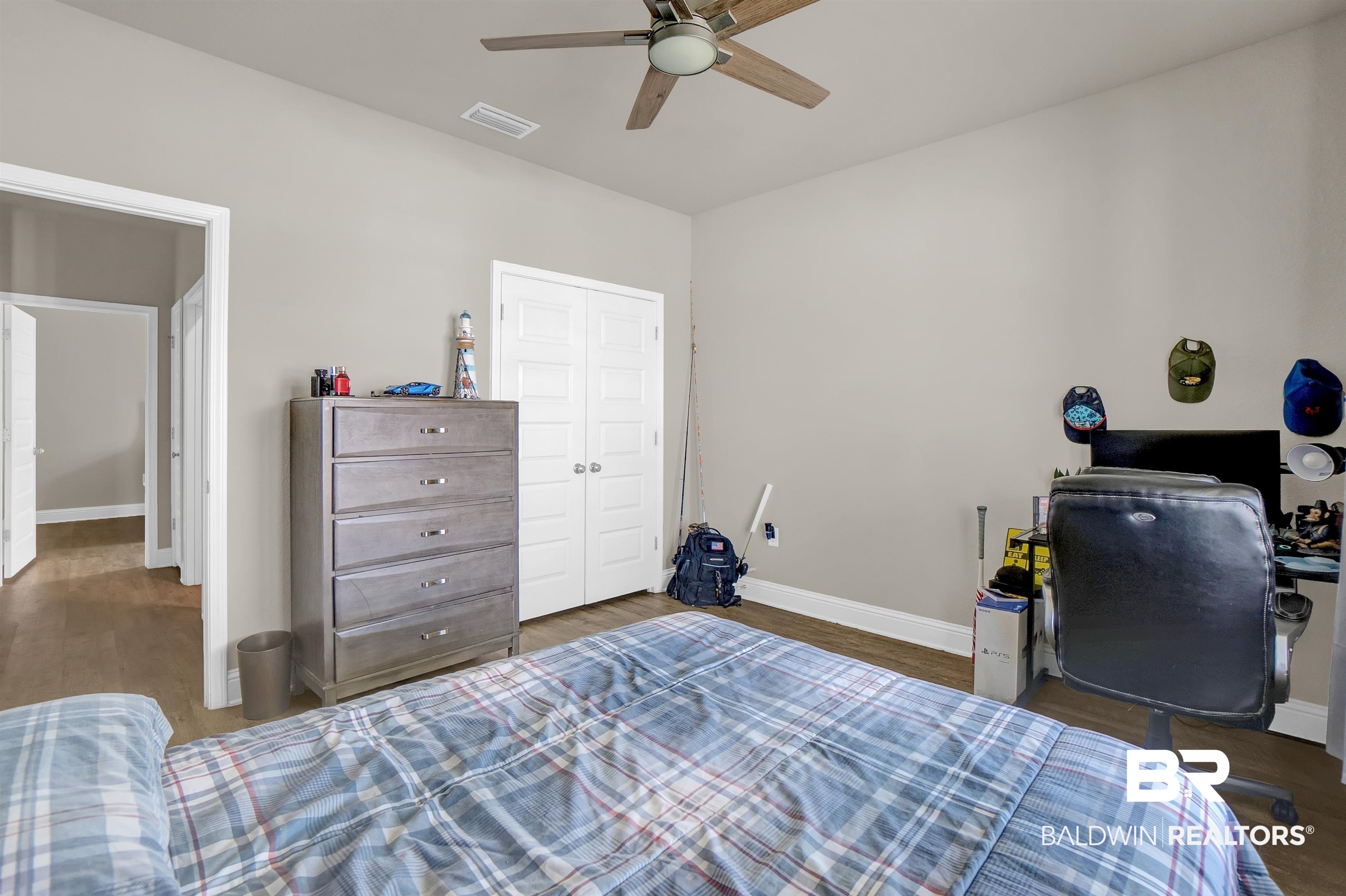 31671 Memphis Loop Daphne, AL 36527 - Photo 12 of 51 Bedroom featuring baseboards, ceiling fan, visible vents, a closet, and wood finished floors