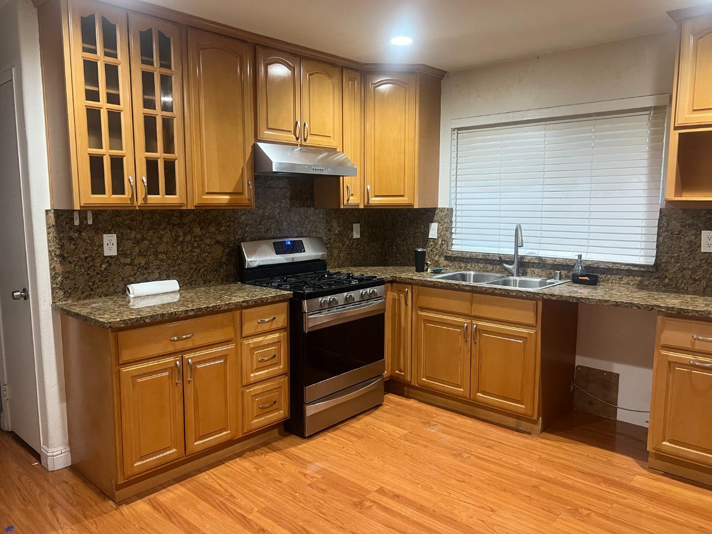 33710 Shylock Drive Fremont, CA 94555 - Photo 2 of 4 a kitchen with stainless steel appliances granite countertop a stove a sink and a microwave