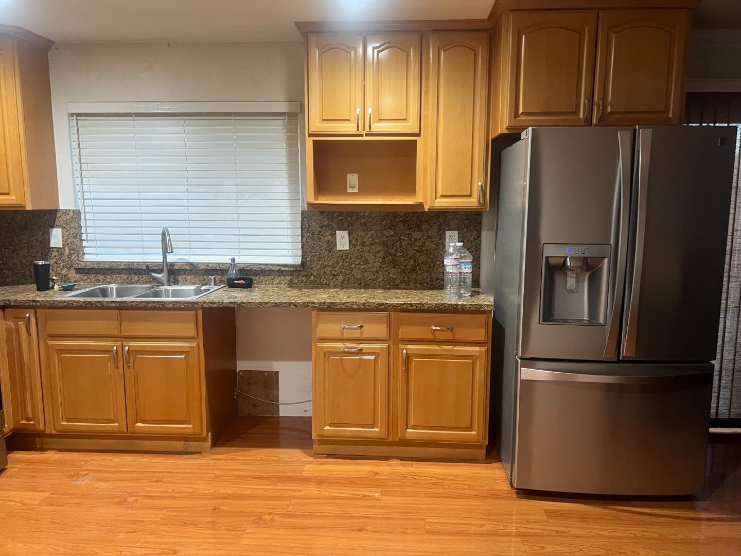 33710 Shylock Drive Fremont, CA 94555 - Photo 3 of 4 a kitchen with granite countertop stainless steel appliances and refrigerator