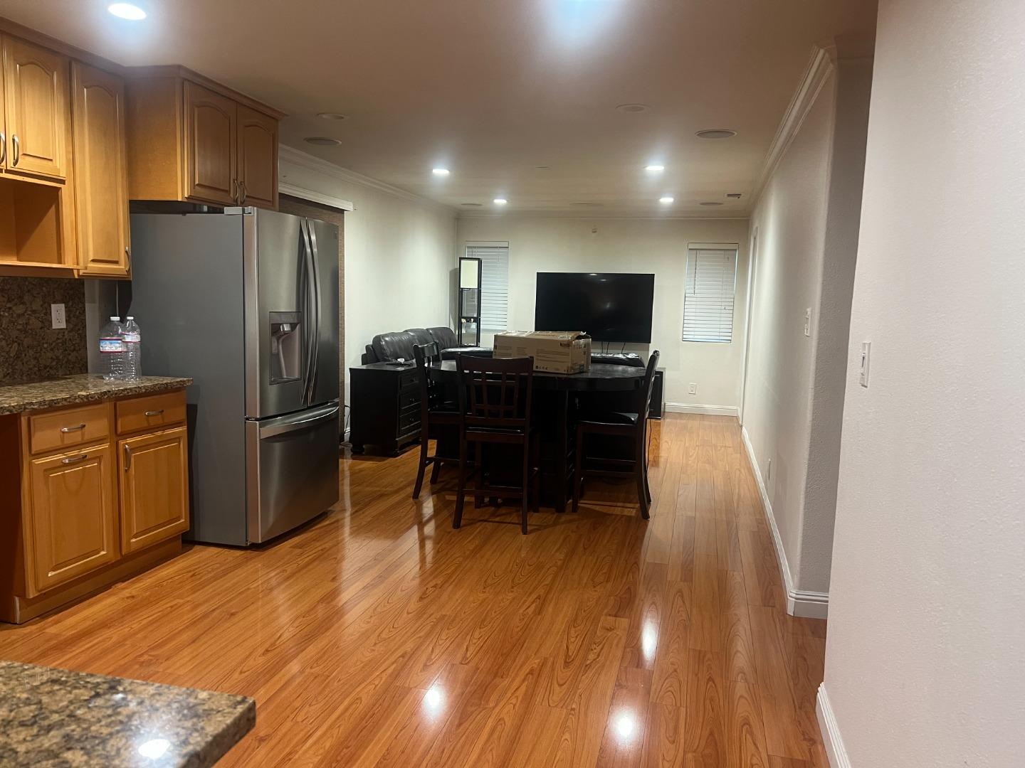 33710 Shylock Drive Fremont, CA 94555 - Photo 4 of 4 a kitchen with a refrigerator coffee maker on the counter top and wooden floor