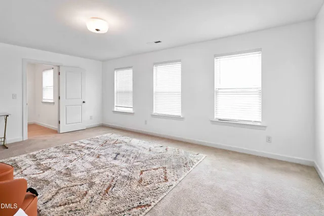 a bed room with two beds and a chair