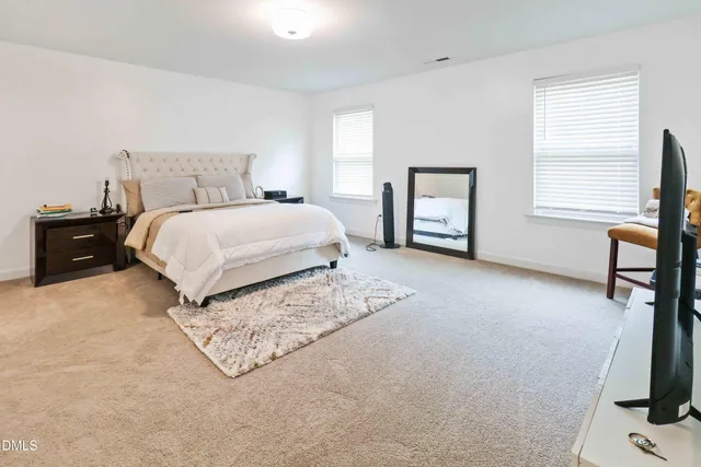 a bedroom with a bed and a lamp with window