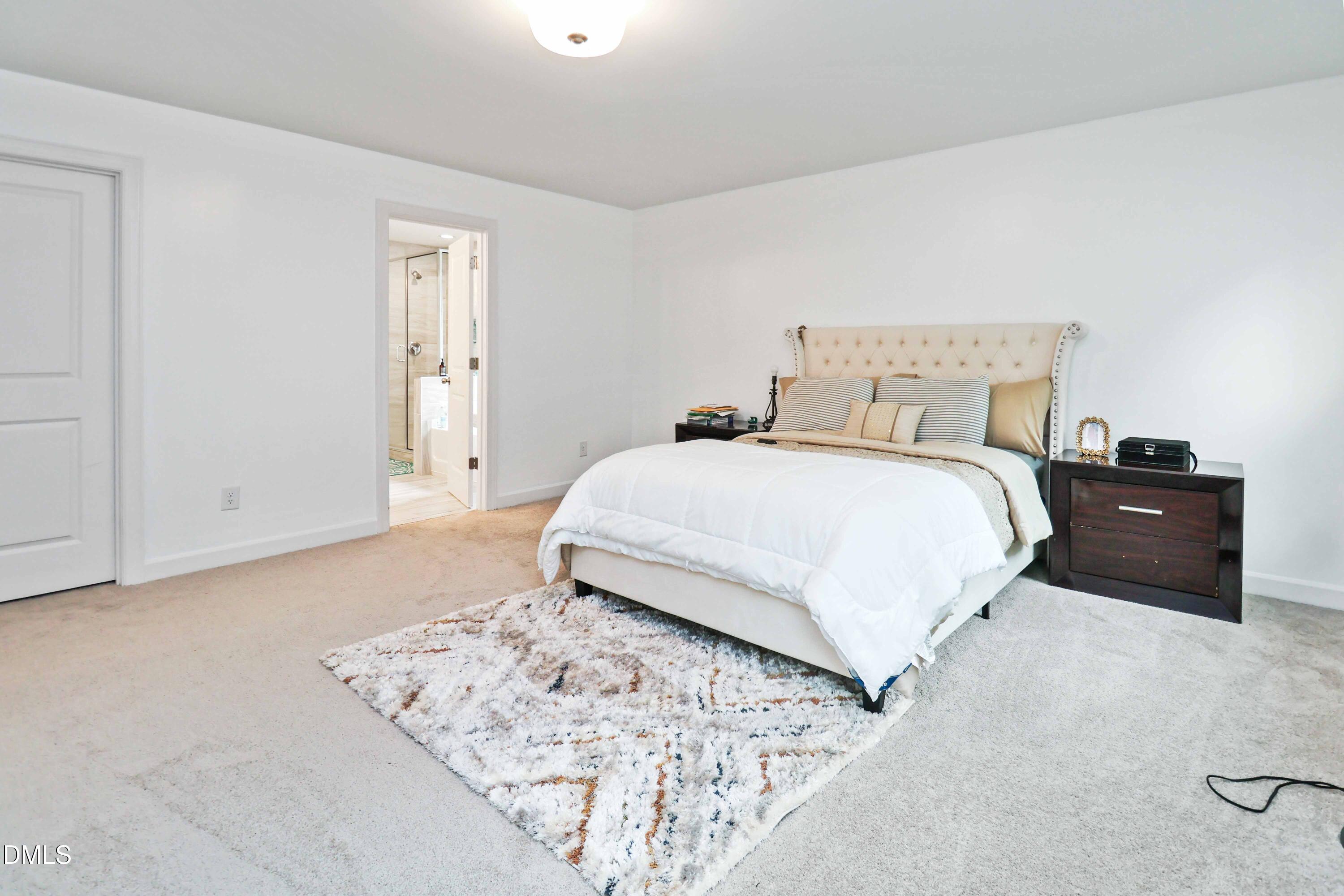 396 Bent Willow Drive Clayton, NC 27527 - Photo 25 of 36 a bedroom with a bed and a lamp with window