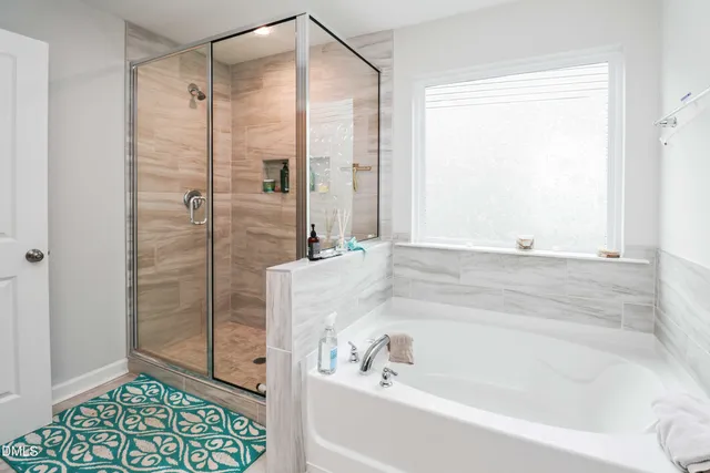 a bathroom with a sink toilet tub and shower
