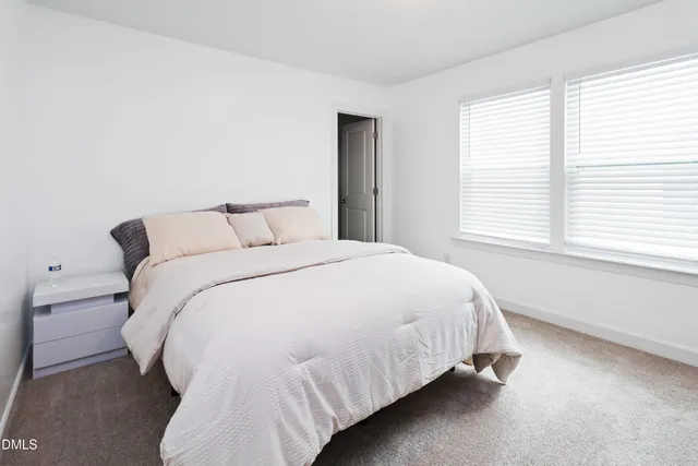 a bedroom with a bed and a night stand