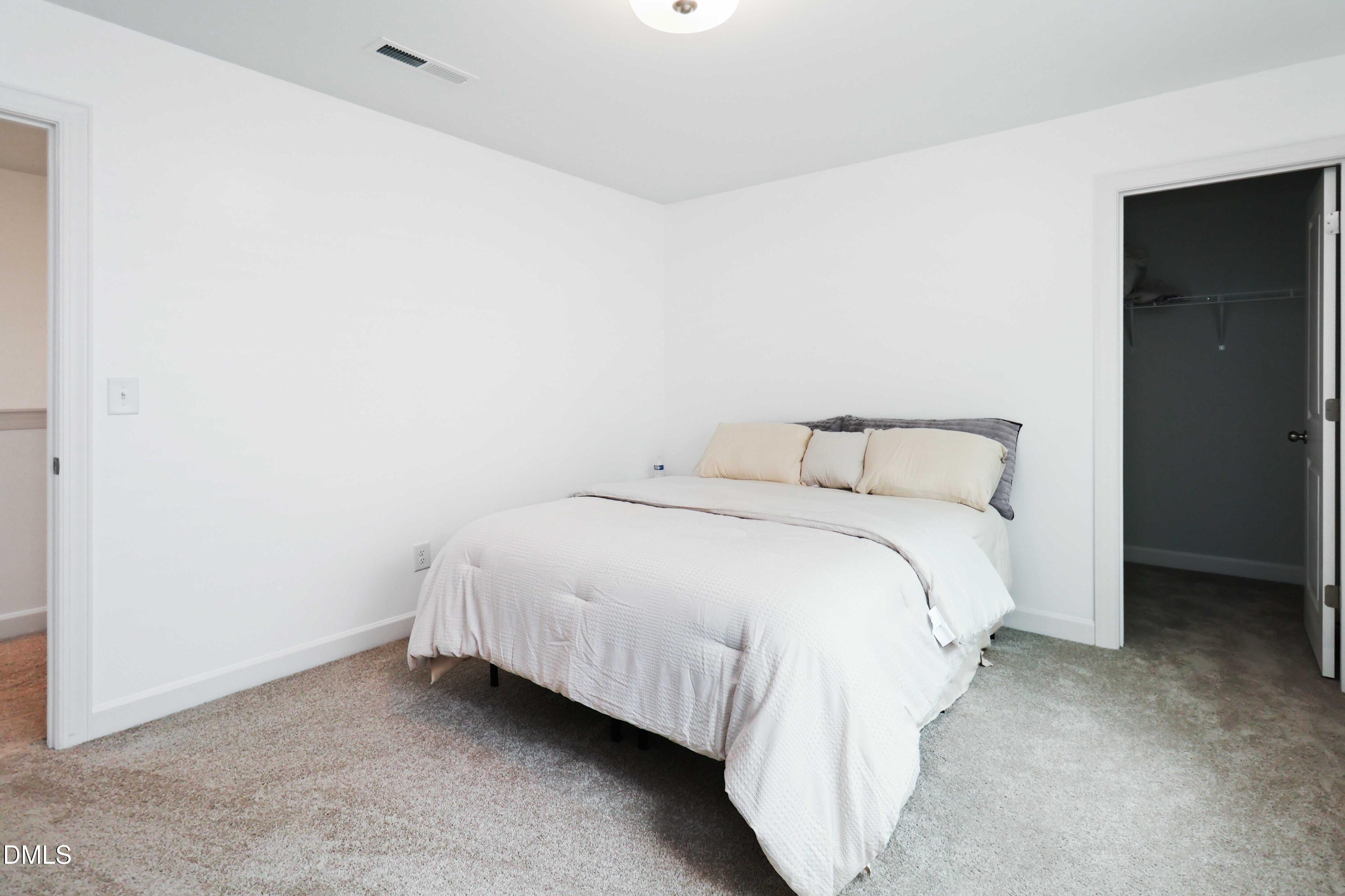 396 Bent Willow Drive Clayton, NC 27527 - Photo 31 of 36 a bedroom with a bed and a night stand