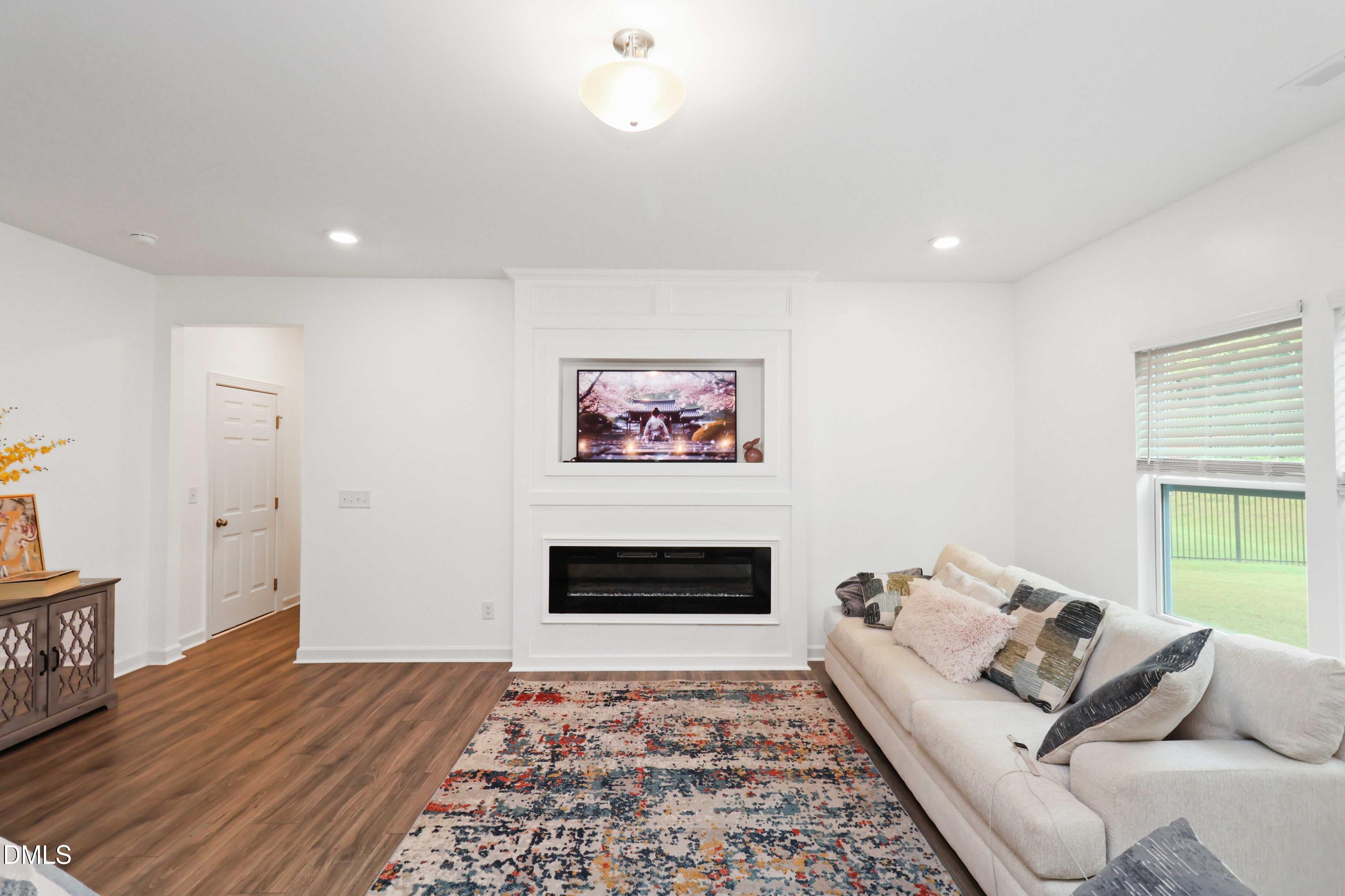 396 Bent Willow Drive Clayton, NC 27527 - Photo 8 of 36 a living room with furniture and a rug