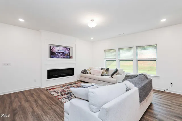 a living room with furniture tv and a large window
