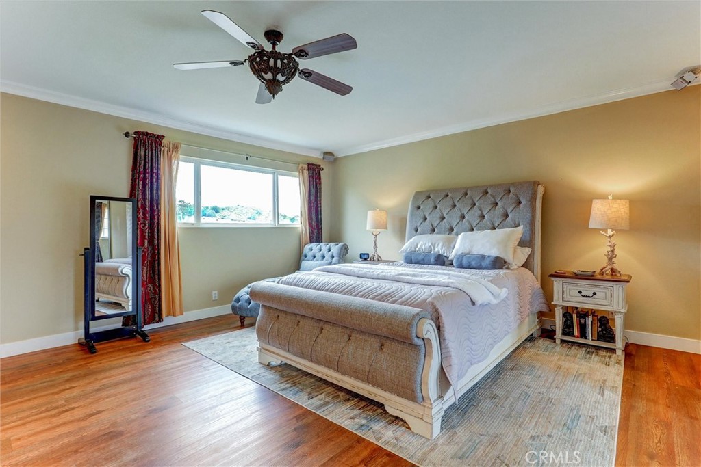 19238 Castlebay Lane Porter Ranch, CA 91326 - Photo 23 of 38 a bedroom with a bed and a chandelier