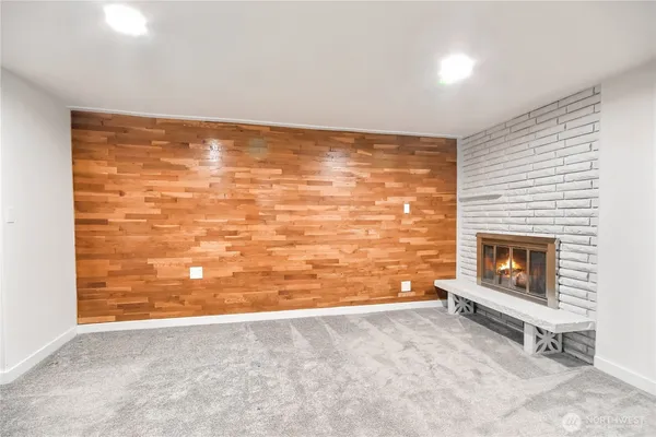 a view of an empty room with a fireplace