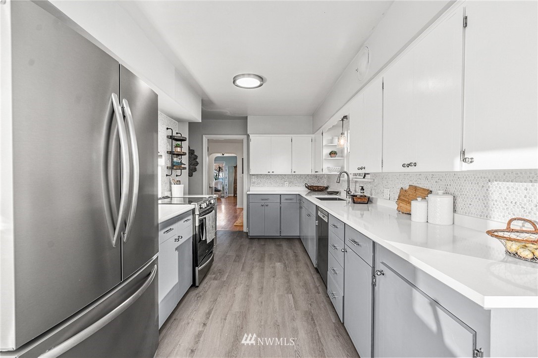 2018 Rucker Avenue Everett, WA 98201 - Photo 14 of 35 a kitchen with refrigerator a sink and cabinets