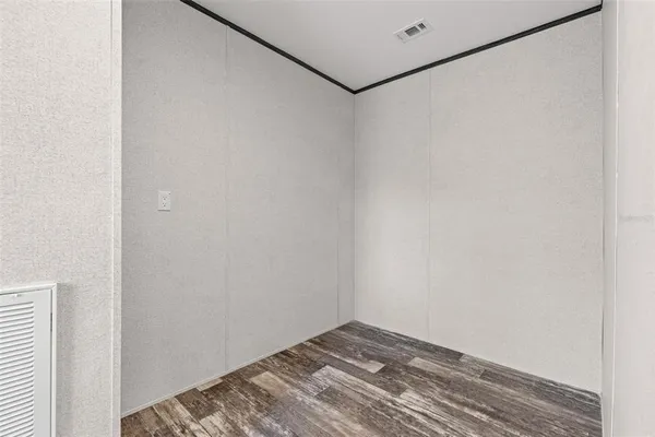 a view of a room with wooden floor