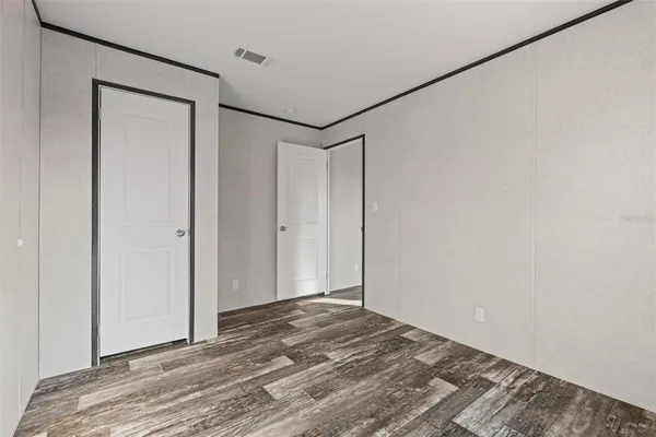 a view of a room with wooden floor