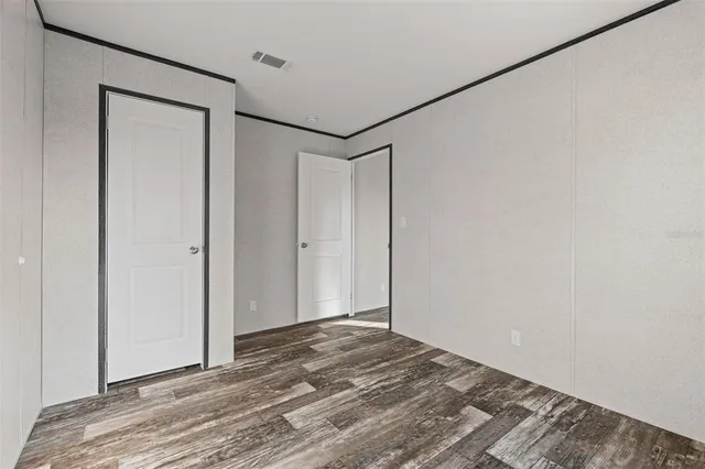 a view of a room with wooden floor