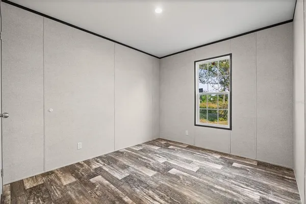 a view of a room with a bed and a window