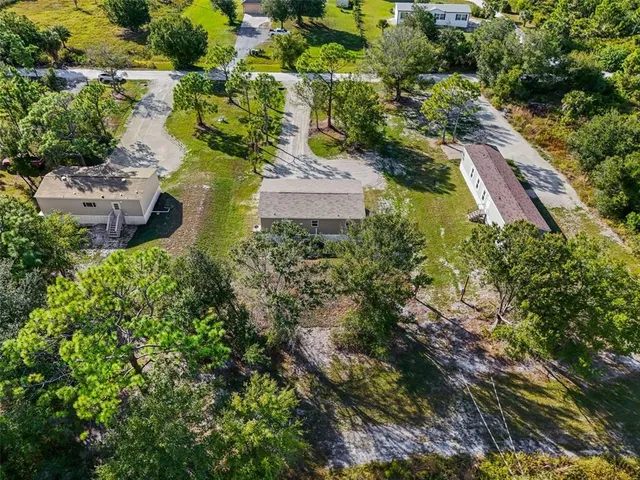 an aerial view of residential house with outdoor space and swimming pool