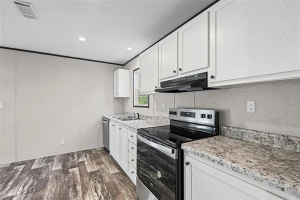 a kitchen with a stove and a sink