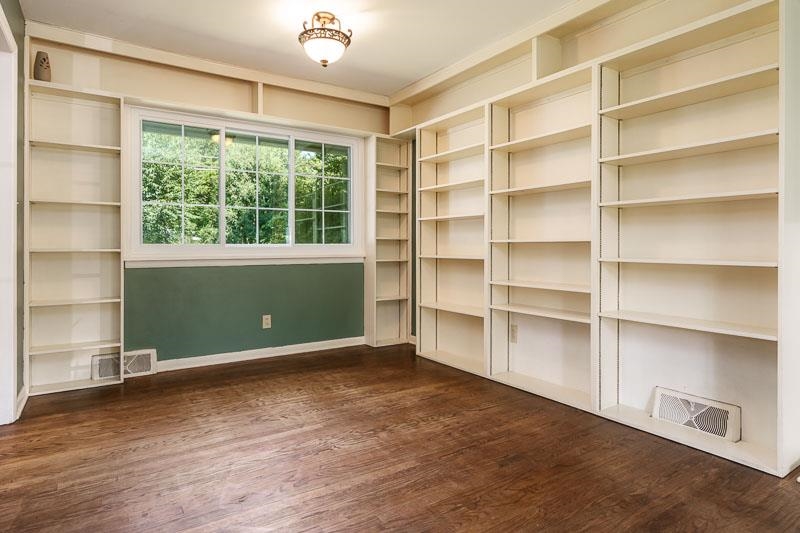 4902 Highcrest Road Rockford, IL 61107 - Photo 11 of 43 a view of an empty room with a window and wooden floor