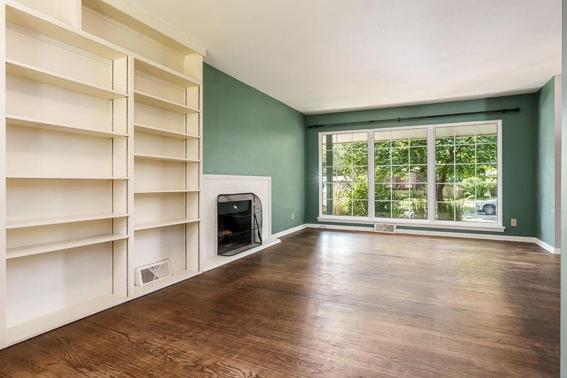 4902 Highcrest Road Rockford, IL 61107 - Photo 12 of 43 a view of an empty room with a fireplace and a window