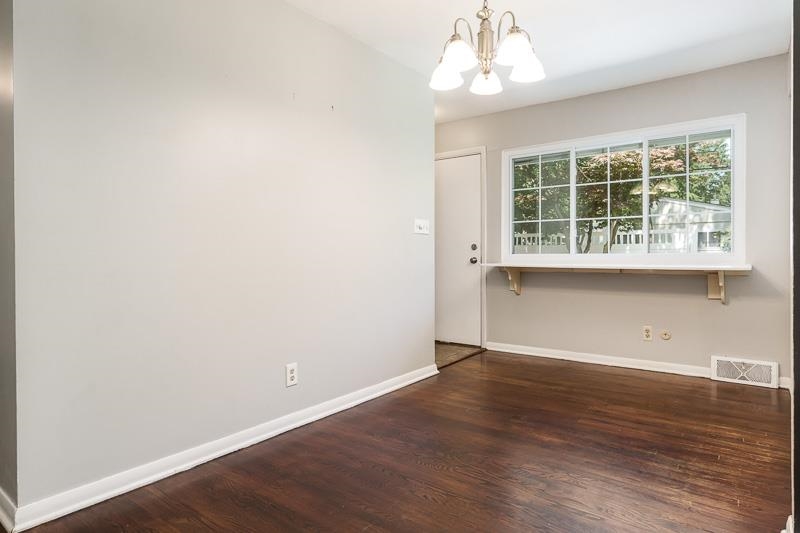 4902 Highcrest Road Rockford, IL 61107 - Photo 19 of 43 an empty room with wooden floor and windows