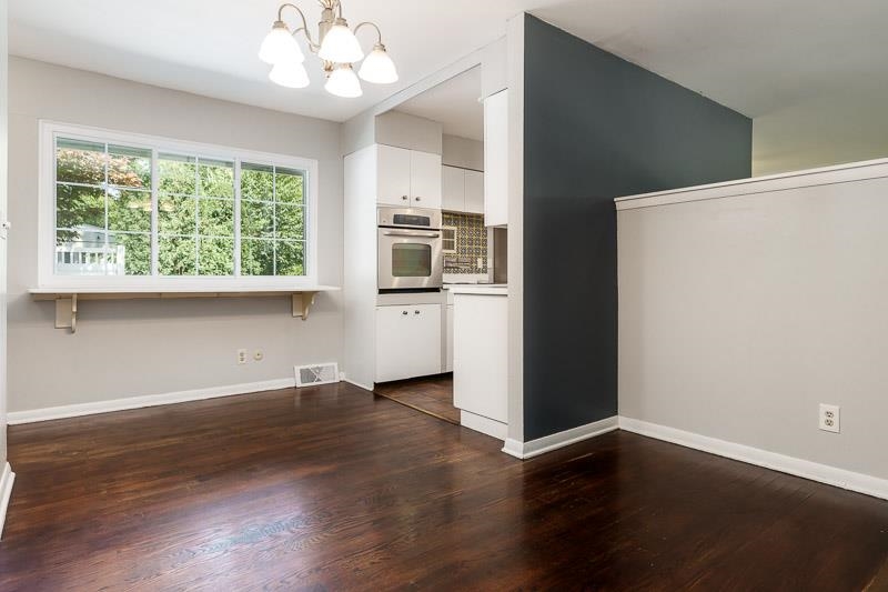 4902 Highcrest Road Rockford, IL 61107 - Photo 20 of 43 a view of an empty room with wooden floor and a window