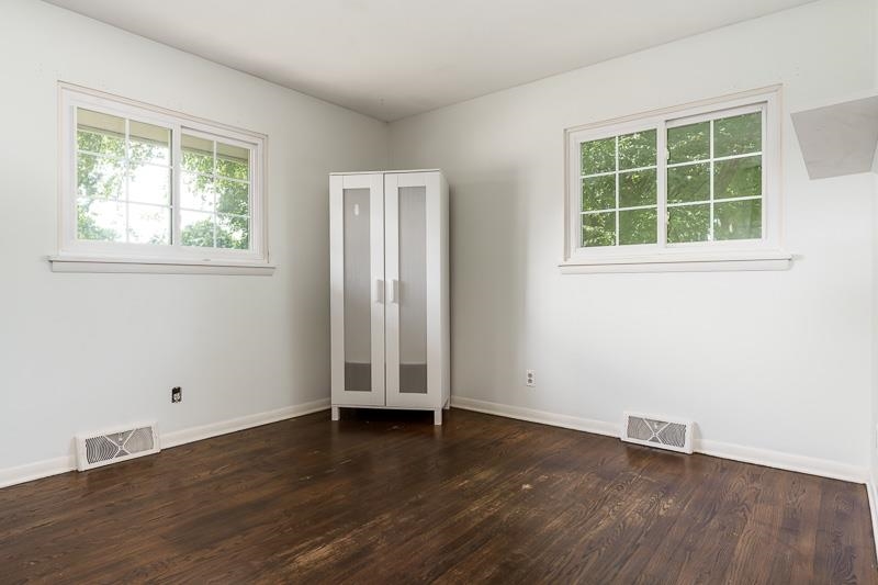 4902 Highcrest Road Rockford, IL 61107 - Photo 23 of 43 an empty room with wooden floor and windows