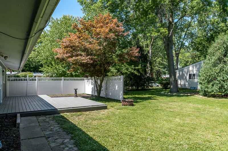 4902 Highcrest Road Rockford, IL 61107 - Photo 41 of 43 a view of a backyard with a wooden fence
