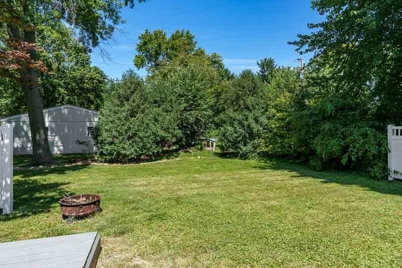 4902 Highcrest Road Rockford, IL 61107 - Photo 42 of 43 a view of a backyard with potted plants and large trees