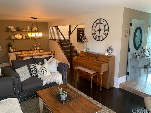 838 Live Oak Place Corona, CA 92882 - Photo 13 of 34 a living room with furniture a clock and wooden floor