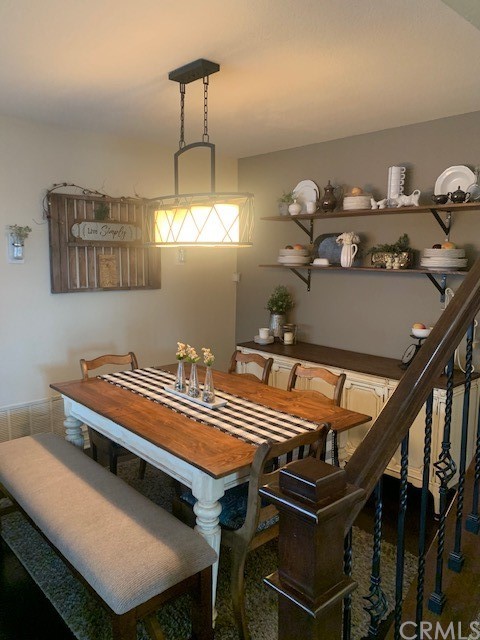 838 Live Oak Place Corona, CA 92882 - Photo 15 of 34 a bedroom with a bed and chandelier