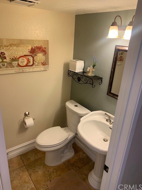 838 Live Oak Place Corona, CA 92882 - Photo 16 of 34 a white toilet sitting next to a bathroom sink