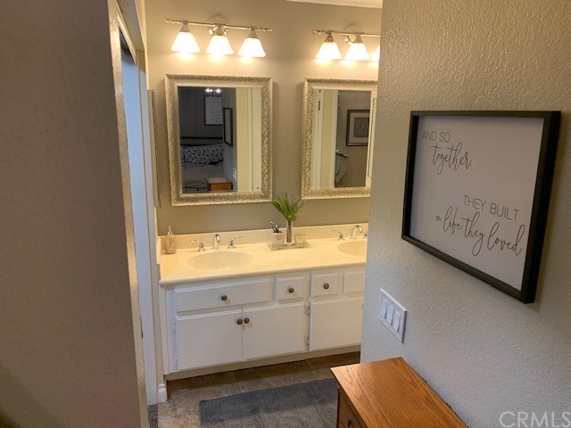 838 Live Oak Place Corona, CA 92882 - Photo 20 of 34 a bathroom with double vanity sink and a mirror