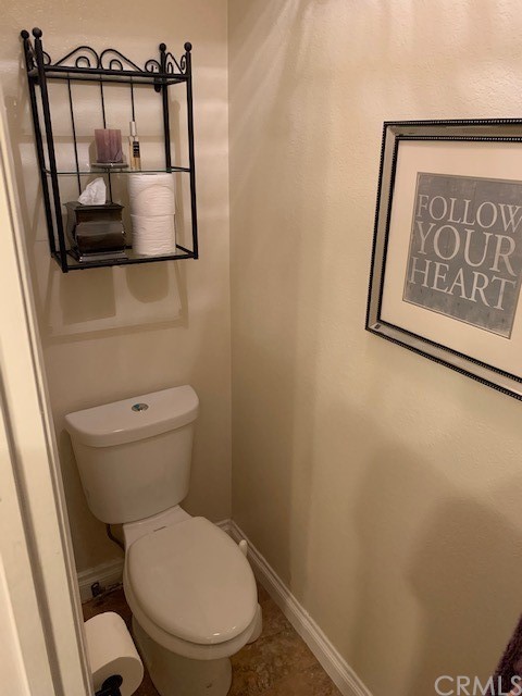 838 Live Oak Place Corona, CA 92882 - Photo 23 of 34 a white toilet sitting next to a shower curtain