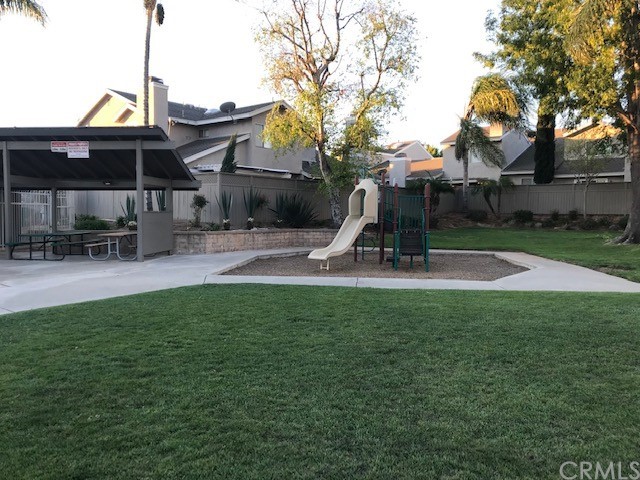 838 Live Oak Place Corona, CA 92882 - Photo 32 of 34 a front view of a house with garden and trees