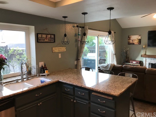 838 Live Oak Place Corona, CA 92882 - Photo 10 of 34 a kitchen with a sink a counter top space and living room view