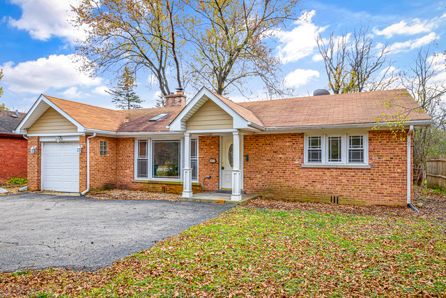 1617 Dundee Road Northbrook, IL 60062 - Photo 1 of 14 a front view of a house with a yard