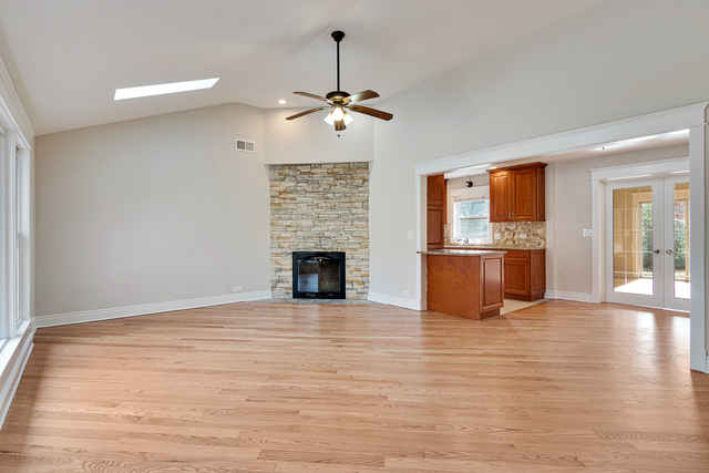 1617 Dundee Road Northbrook, IL 60062 - Photo 3 of 14 a view of empty room with wooden floor fireplace and a window