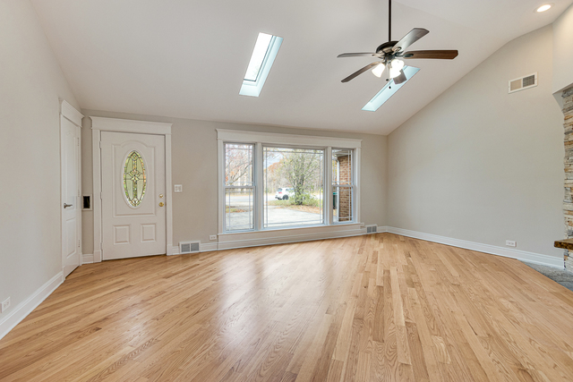 1617 Dundee Road Northbrook, IL 60062 - Photo 4 of 14 a view of an empty room with a window and wooden floor