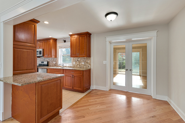 1617 Dundee Road Northbrook, IL 60062 - Photo 5 of 14 a kitchen with stainless steel appliances granite countertop a refrigerator and a sink