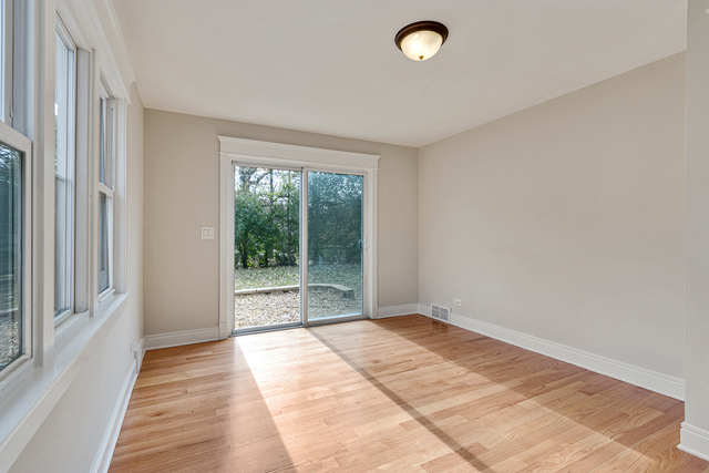 1617 Dundee Road Northbrook, IL 60062 - Photo 8 of 14 a view of an empty room with wooden floor and a window
