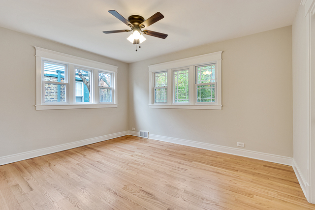 1617 Dundee Road Northbrook, IL 60062 - Photo 9 of 14 a view of an empty room with wooden floor and a window