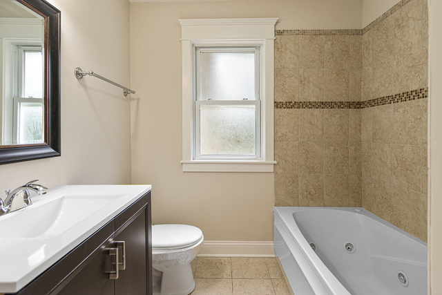 1617 Dundee Road Northbrook, IL 60062 - Photo 10 of 14 a bathroom with a sink toilet and shower