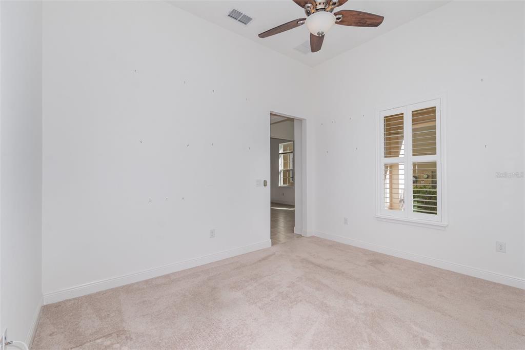 4911 Drawdy Court St. Cloud, FL 34772 - Photo 15 of 37 an empty room with a window and a fan