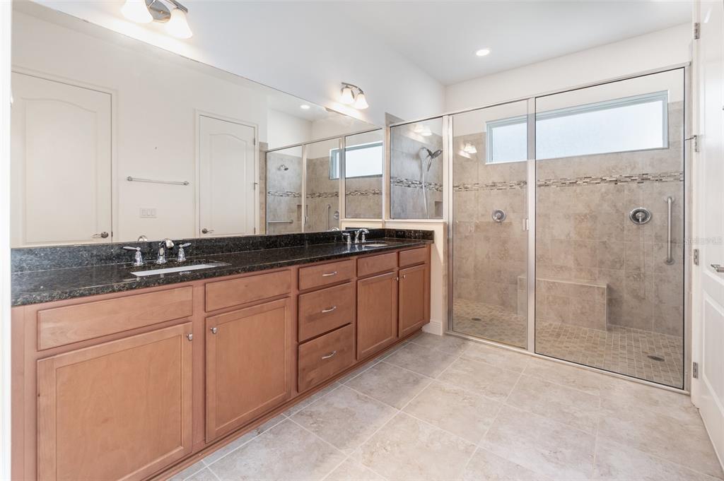 4911 Drawdy Court St. Cloud, FL 34772 - Photo 19 of 37 a spacious bathroom with a shower sink and mirror