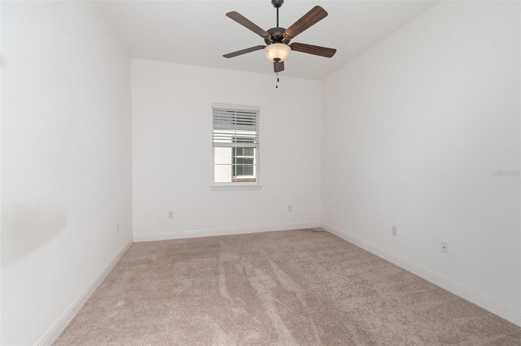 4911 Drawdy Court St. Cloud, FL 34772 - Photo 20 of 37 an empty room with a window and a fan